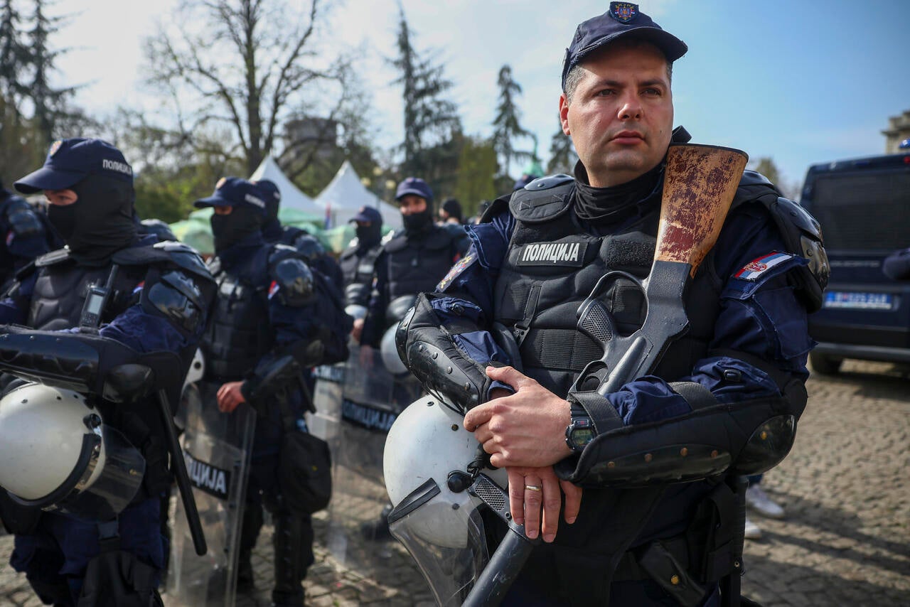 Police officers brace an anti-corruption rally in Belgrade, Serbia,